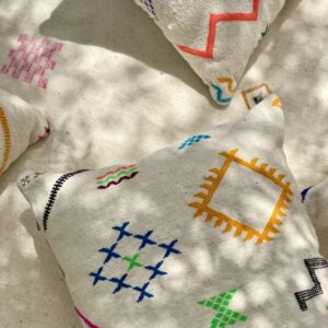 Handmade Moroccan cushion with neon embroidery on white wool