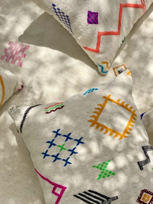 Handmade Moroccan cushion with neon embroidery on white wool